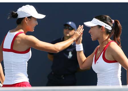 Zheng Jie (R) and Yan Zi of China celebrate one point during their first round match against Agnieszka Radwanska and Urszula Radwanska of Poland at the US Open tennis tournament August 28, 2008 in Flushing Meadows, NY. 