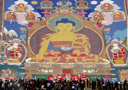 A huge Buddhist image on a large tangka, a kind of scroll painting mounted on brocade,is being displayed at the opening ceremony of the Shoton (Yogurt) Festival celebration in Zhaibung Monastery in Lhasa, capital of Tibet Autonomous Regional, August 30, 2008. Tangka Paintings display is one of the various activities held during the Shoton Festival.