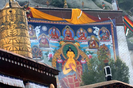 A huge Buddhist image on a large tangka, a kind of scroll painting mounted on brocade,is being displayed at the opening ceremony of the Shoton (Yogurt) Festival celebration in Zhaibung Monastery in Lhasa, capital of Tibet Autonomous Regional, August 30, 2008. Tangka Paintings display is one of the various activities held during the Shoton Festival.
