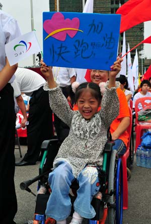 A girl cheers during the Beijing 2008 Paralympic torch relay in Changsha, capital of central China's Hunan Province, China, Aug. 31, 2008.