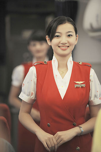 Air hostess Jiang Kangkang smiles as she performs a sign language song 'Smiling' on board, August 30, 2008. Chinese air hostesses get ready for more hearing-challenged passengers during the upcoming Paralympic Games. [Xinhua]