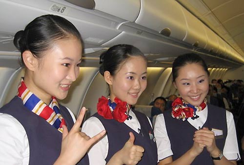 Air hostesses use sign language on board, August 29, 2008. Chinese air hostesses get ready for more hearing-challenged passengers during the upcoming Paralympic Games. [Xinhua]