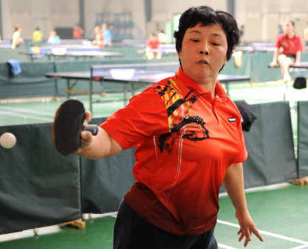 Zhang Xiaoling, five-time Paralympic table tennis champion, trains in Xi'an of northwest China's Shaaxi Province, March 25, 2008. Zhang has competed in five consecutive Paralympics and won ten gold medals in total. She will compete in her sixth Paralympics in Beijing. [Xinhua] 