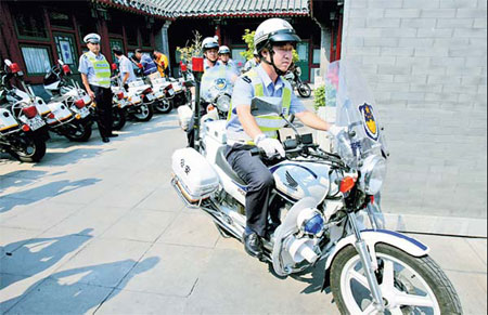 One of Yao Weizong's traffic police wheels out of the team's courtyard station yesterday for a routine patrol. [Lu Zhongqiu/China Daily]