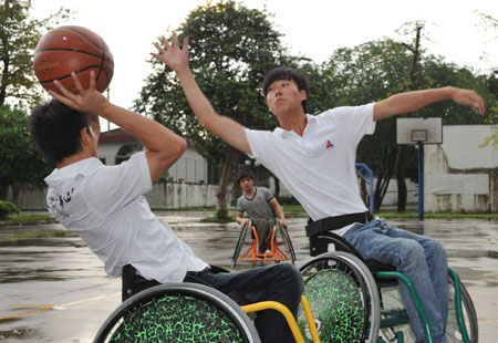 Two students on wheelchair play basketball in a technical secondary school specially for disabled students in Guangzhou of South China's Guangdong Province September 4, 2008. [Xinhua] 