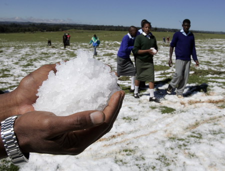 A villager holds ice after heavy hailstorms hit a deforested hillside in Gikingi Village in Nyahururu town, some 220km from Nairobi, September 3, 2008. [Agencies]