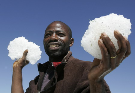 A villager holds ice after heavy hailstorms hit a deforested hillside in Gikingi Village in Nyahururu town, some 220km from Nairobi, September 3, 2008. [Agencies]