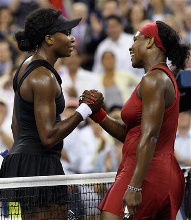 Serena Williams, right, of the United States, shakes hands with her sister Venus Williams, of the United States, after Serena won their quarter final match at the US Open tennis tournament in New York, yesterday.  
