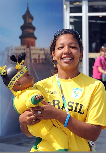 An athlete of Brazil has photos taken with a toy in her arms at the Paralympic Village in Beijing on September 5, 2008. Athletes and delegates from all over the world gathered in Beijing to attend the Beijing 2008 Paralympic Games which will be opened on September 6, 2008. 