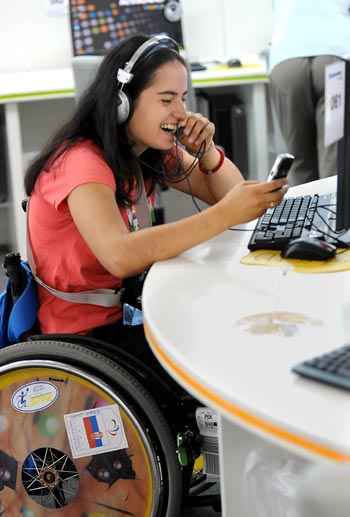 An athlete communicates with her ralatives in an internet cafe at the Paralympic Village in Beijing on September 5, 2008. Athletes and delegates from all over the world gathered in Beijing to attend the Beijing 2008 Paralympic Games which will be opened on September 6, 2008.