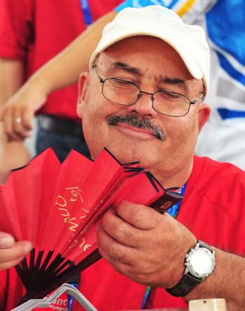 An athlete shows his interest to a folding fan at the Paralympic Village in Beijing on September 5, 2008. Athletes and delegates from all over the world gathered in Beijing to attend the Beijing 2008 Paralympic Games which will be opened on September 6, 2008.