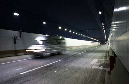 A minivan runs through the Yangtze River Tunnel in Shanghai, September 5, 2008. The world's widest tunnel with an inner diameter of 13.7 meters completed its excavation in Shanghai under the Yangtze River on Friday. The 8.9-km tunnel is part of a 12.6 billion yuan (US$1.84 billion) bridge and tunnel project to link Shanghai with Chongming Island, the country's third largest after Taiwan and Hainan.(Xinhua Photo)
