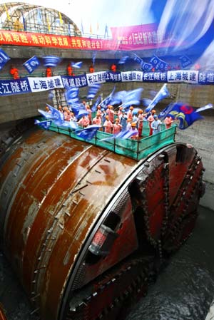 Workers celebrate the completion of the Yangtze River Tunnel in Shanghai, September 5, 2008. The world's widest tunnel with an inner diameter of 13.7 meters completed its excavation in Shanghai under the Yangtze River on Friday. The 8.9-km tunnel is part of a 12.6 billion yuan (US$1.84 billion) bridge and tunnel project to link Shanghai with Chongming Island, the country's third largest after Taiwan and Hainan. (Xinhua photo)