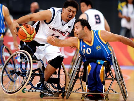 Sweden's Hussein Haidari(R) defenses Japan's Tomohiko Oshima in men's wheelchair basketball heat at the Beijing 2008 Paralympic Games in Beijing, Sept. 7, 2008. Sweden won 61-49.