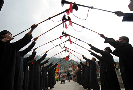 People blow the suona horns during celebrations for the Duan Festival in Duyun, southwest China's Guizhou Province, September 7, 2008.