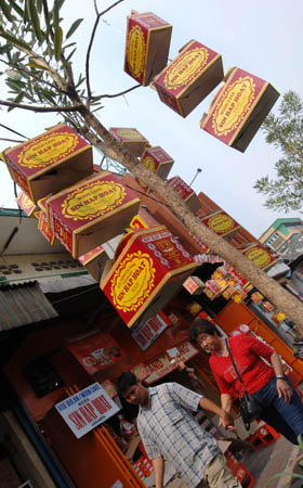 Boxes for moon cakes are hung on the outside of a shop at China Town, Pancoran in Jakarta, Indonesia, Sept. 7, 2008. Large amount of moon cakes came into the market in Jakarta before the traditional Chinese Mid-Autumn Festival which falls on Sept. 14 this year. [Yue Yuewei/Xinhua]