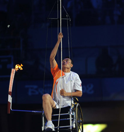 Hou Bin pulls himself up in his wheelchair to light the cauldron during the opening ceremony of Beijing Paralympics September 6. 