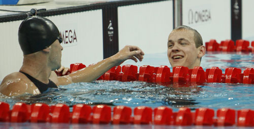 Dzmitry Salei (R) of Belarus won the gold medal in the S13 final of Men's 100m Butterfly.