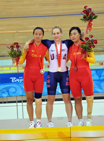 Medalists stand on the podium. 