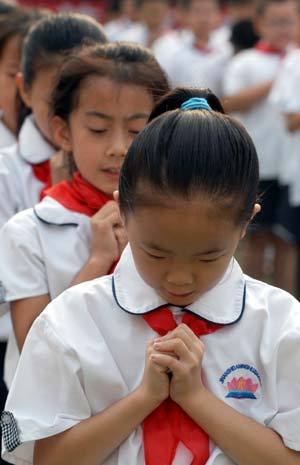 Students perform a song in sign language during a Teacher's Day celebration held at Daminghulu Primary School in Jinan, capital of east China's Shandong Province, Sept. 8, 2008. 
