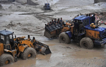 Workers are transported to the mudslide area to conduct rescue operations in Xiangfen County of north China's Shanxi Province, September 8, 2008. At least 26 people were killed on Monday in a rain-triggered mud-rock flow that caused the collapse of a warehouse holding waste ore dregs in Shanxi Province. 