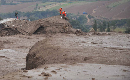 Rescuers search through houses buried in the mud after the accident in Xiangfen County of north China's Shanxi Province, September 8, 2008.