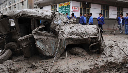 A car destroyed by the mud-rock flow is seen in Xiangfen County of north China's Shanxi Province, September 8, 2008. At least 26 people were killed on Monday in a rain-triggered mud-rock flow that caused the collapse of a warehouse holding waste ore dregs in Shanxi Province. 