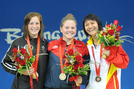 Gold medalist Anna Eames (C) of the United States, silver medalist Sophie Pascoe of New Zealand and bronze medalist Wang Shuai of China pose on the podium during the awarding ceremony of the S10 final of women's 100m butterfly of the Beijing 2008 Paralympic Games at the National Aquatics Center in Beijing, Sept. 8, 2008. (Xinhua/Yang Shiyao) 