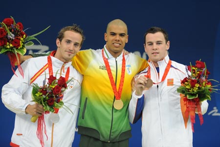 Andre Brasil of Brazil (C), David Julian Levecq of Spain (L) and Mike van der Zanden of the Netherlands pose on the podium during the awarding ceremony of the S10 final of men's 100m butterfly of the Beijing 2008 Paralympic Games at the National Aquatics Center in Beijing, Sept. 8, 2008. (Xinhua/Yang Shiyao)