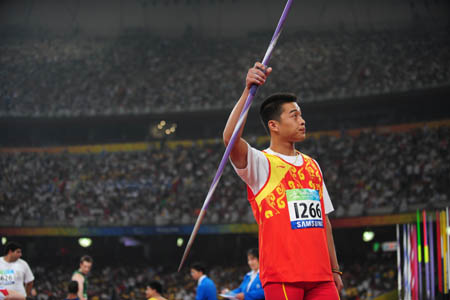 China's Guo Wei gestures to the spectators during the men's javelin F35/36 final at the National Stadium，also known as the Bird's Nest，during the Beijing 2008 Paralympic Games in Beijing, China, Sept. 8, 2008. Guo won the gold medal with 56.07 meters and set a new world record. (Xinhua/Li Ga)