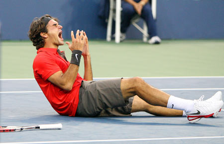 Roger Federer of Switzerland celebrates match point beating Andy Murray of Britain for his fifth straight U.S. Open tennis title at Flushing Meadows in New York Sept. 8, 2008. 