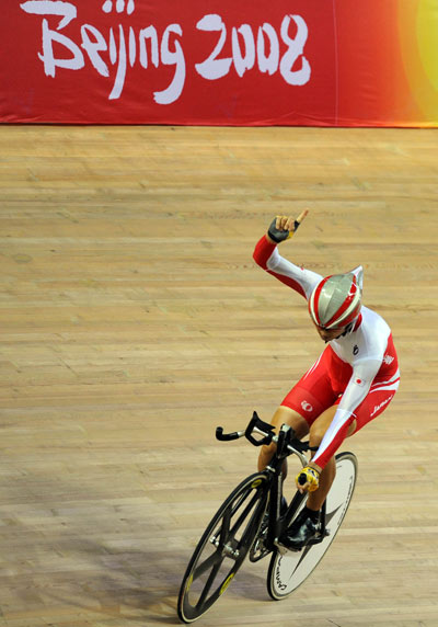 Japan's Ishii Masashi finished in a new world record time of one minute and 8.771 seconds to claim the Men's Cycling Track 1km Time Trial (CP4) gold medal on September 9, 2008. 