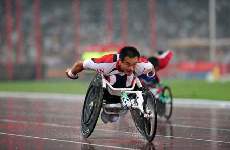 Japan's Susumu Kangawa competes in the rain during the first round competition of men's 400m T53 of the Beijing 2008 Paralympic Games, at the National Stadium, also known as the Bird's Nest, in Beijing, China, Sept. 9, 2008. (Xinhua/Li Ga)