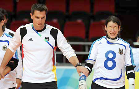 A German coach guides the country's players into the court at the 2008 Paralympic women's goalball match in Beijing, China, Sept. 8, 2008. 