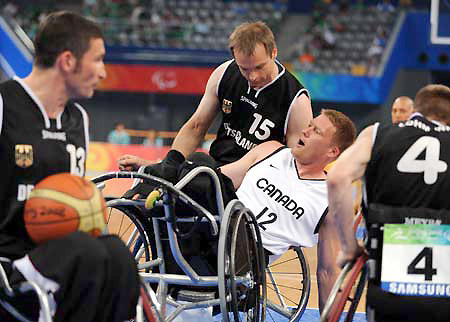 Patrick Anderson(C) of Canada competes during a men's wheelchair basketball preliminary match between Canada and Germany at the Beijing 2008 Paralympic Games in Beijing, September 7, 2008. Canada won the match 62-59. 