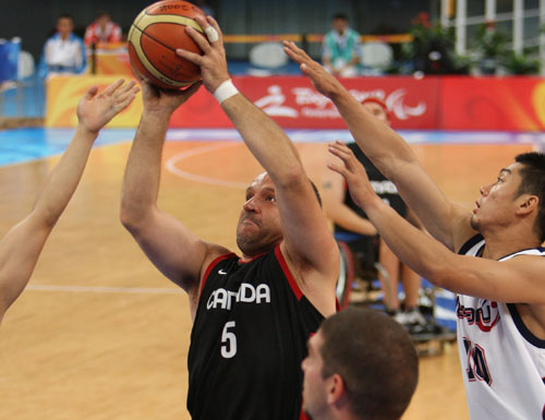 Yvon Rouillard (1st L) of Canada shoots. Canada beats Japan 75-48 to advance in Men's Wheelchair Basketball preliminary match at the Beijing 2008 Paralympic Games in Beijing on September 10, 2008. 