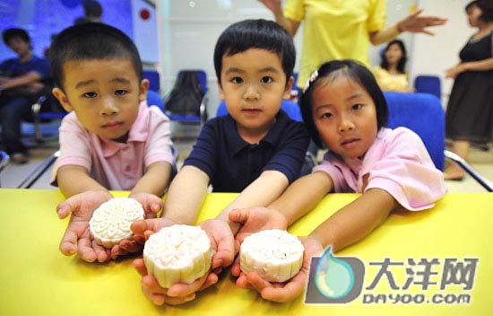 Kids display self-make moon cakes in Guangzhou on Tuesday, September 9, 2008. [Photo: dayoo.com]