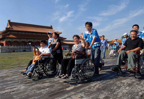 At Beijing's Palace Museum,a 1,000-meter barrier-free pathway allows wheelchair visitors to go along the central axis of the palace.A group of disabled people, visits at the Palace Museum,September 10, 2008. [Xinhua] 