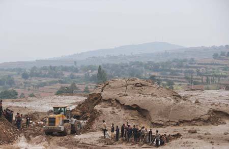 Rescuers search for survivors in houses hit by mud-rock flow at the Tashan Mine in Xiangfen County under Linfen City of north China's Shanxi Province. Eight more deaths were reported Tuesday morning in north China's Shanxi Province, bringing the death toll from the rain-triggered mud-rock flow that caused the collapse of a warehouse to 34, the local rescue headquarters said on Tuesday.