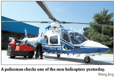 A policeman checks one of the new helicopters.