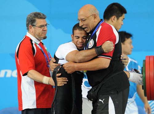 Sherif Othman Othman of Egypt (L2) celebrates with his coach. He lifted 202.5kg to break the world record and claim the title of the Men's Powerlifting 56kg at the Beijing 2008 Paralympic Games in Beijing on September 11, 2008.