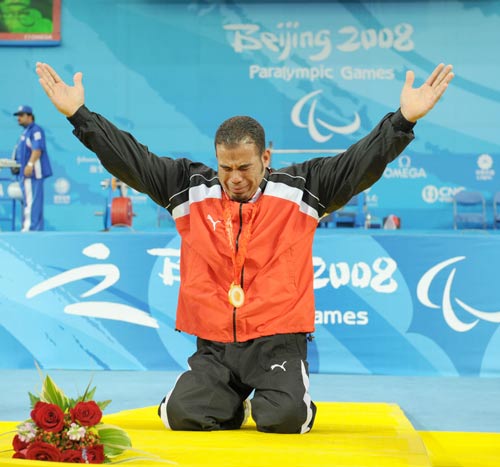 Sherif Othman Othman of Egypt cries on the podium. He lifted 202.5kg to break the world record and claim the title of the Men's Powerlifting 56kg at the Beijing 2008 Paralympic Games in Beijing on September 11, 2008.