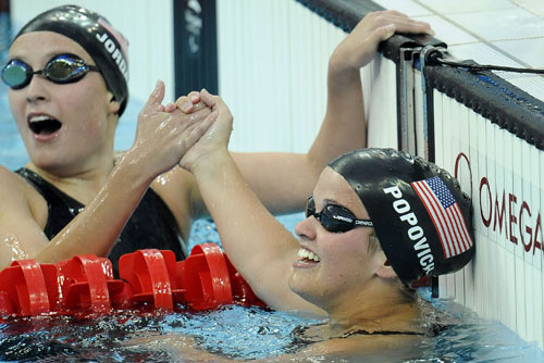 Erin Popovich (R) of the United States receives congratulations. She won the Women's 400m Freestyle S7 gold medal, with a time of five minutes and 17.41 seconds, at the National Aquatics Center in Beijing on September 11, 2008.