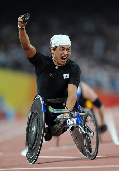 Hong Suk-man of the Republic of Korea celebrates after his win. He won the gold medal of the Men's 400m T53 with 47.67 seconds to set a new world record at the National Stadium,also known as the Bird's Nest,during the Beijing 2008 Paralympic Games on September 11, 2008. 