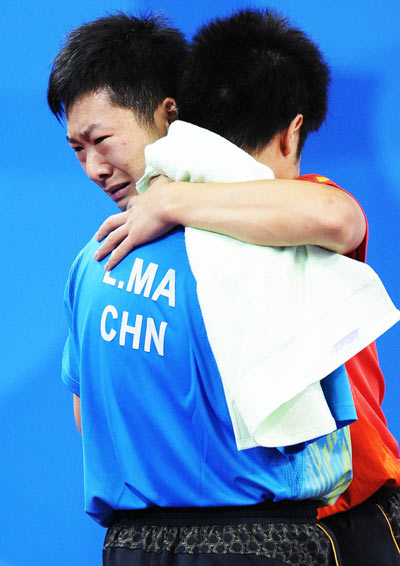 Ge Yang of China (in red) hugs his opponent and compatriot Ma Lin. He beat the latter 3-1 and claimed the title of the Men's Individual Class 9-10 of the Beijing 2008 Paralympic Games table tennis event on September 11.