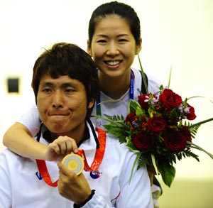 South Korean athlete Lee Ji-Seok poses for photos with his wife Park Kyoung-Sun after winnning in the Mixed R4-10m Air Rifle Standing SH2 final with a total of 704.3 in Beijing Paralympic Shooting event at the Beijing Shooting Range Hall Sept. 11, 2008. 