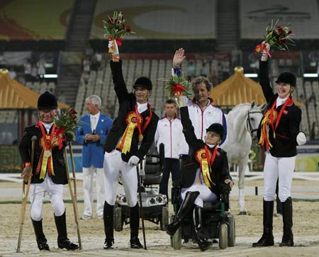 Members of Britain's equestrian team wave during the Overall Team awarding ceremony of the Beijing 2008 Paralympic Games Equestrian event at Hong Kong Equestrian Venue (Sha Tin) Sept. 11, 2008. British team won gold, German team took silver and Norwegian team took bronze. [Xinhua] 