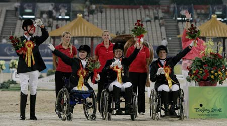 Members of Germany's equestrian team wave during the Overall Team awarding ceremony of the Beijing 2008 Paralympic Games Equestrian event at Hong Kong Equestrian Venue (Sha Tin) Sept. 11, 2008. British team won gold, German team took silver and Norwegian team took bronze. [Xinhua] 