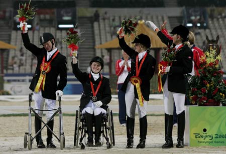 Members of Norway's equestrian team wave during the Overall Team awarding ceremony of the Beijing 2008 Paralympic Games Equestrian event at Hong Kong Equestrian Venue (Sha Tin) Sept. 11, 2008. British team won gold, German team took silver and Norwegian team took bronze. [Xinhua] 