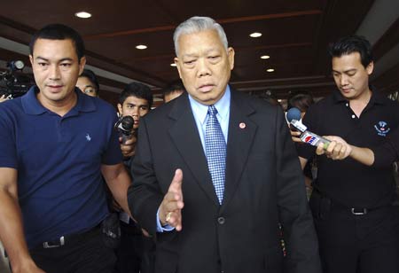 Former Thai Prime Minister Samak Sundaravej walks past journalists while leaving Parliament in Bangkok on September 11, 2008.